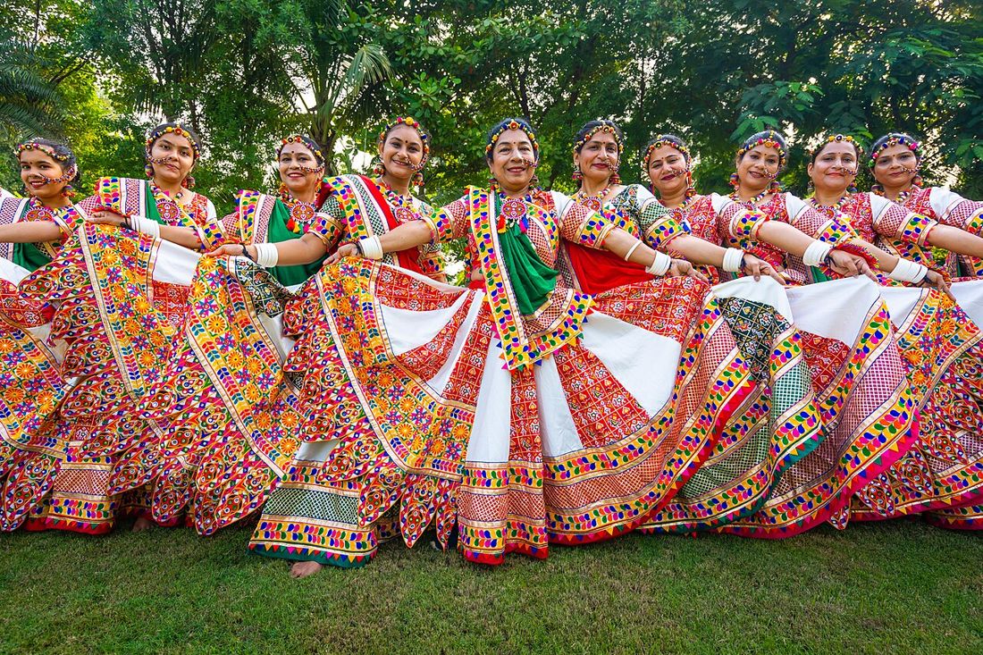Group of women in mirror-work chaniya choli dancing garba at Navratri